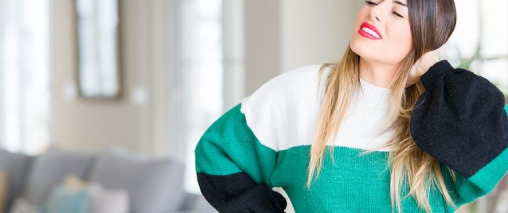 Woman holding her neck as if she has neck pain