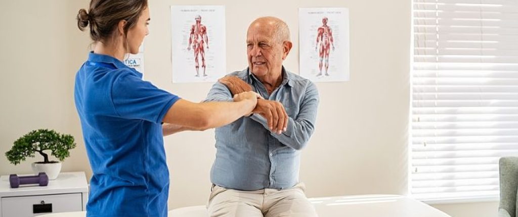 Man being examined for a rotator cuff injury.