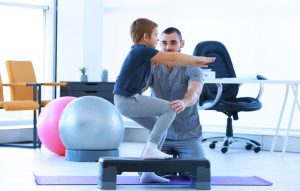 Physical therapist working with a pediatric patient.