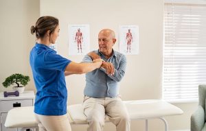 Man being examined for a rotator cuff injury.